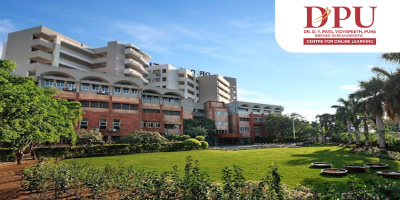 DY Patil Online MBA Building Is Shown In The Image And There Is Logo On The Right Hand Top Corner Of DY Patil.